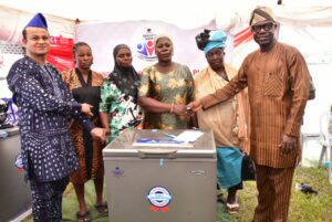 Dangote Cement Ibese Plant Director, Azad Nawabuddin (left) and Permanent Secretary Ogun Ministry of Industry, Trade & Investment, Dr. Aikulola Olu-Ola (right) with some of the Women beneficiaries of the Women Empowerment Scheme at the 2023 Dangote Cement Ibese plant Community Day Celebrations, held at Ibese, Ogun state.